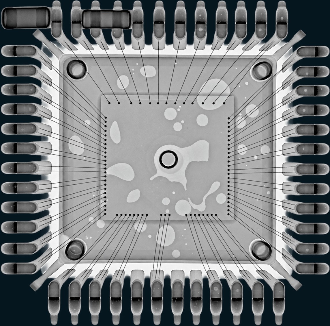X-ray of the same quad flat package with neighbouring surface-mount passives in frame